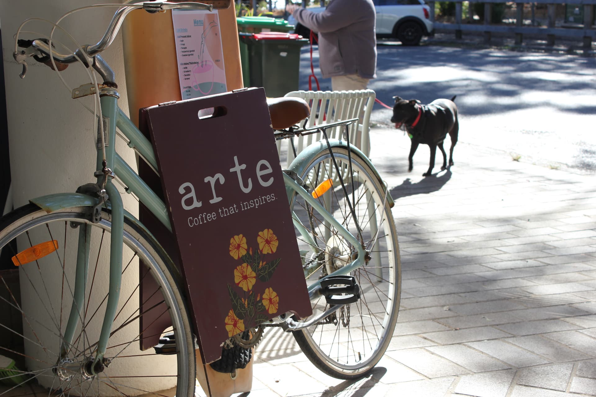 Arte café A-frame sign beside a bicycle on the footpath at Pearl Beach