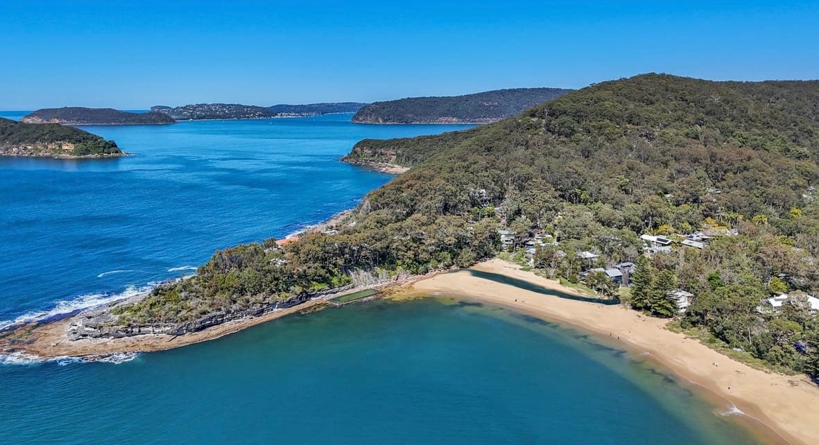 Aerial view of Pearl Beach and the headland, with Broken Bay beyond