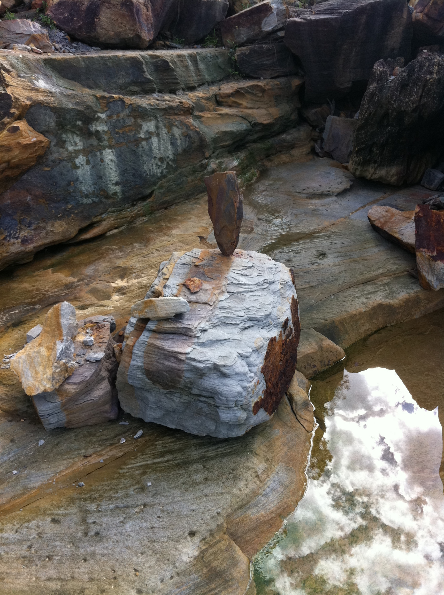 A balanced stone cairn on the sandstone rock shelf at Pearl Beach