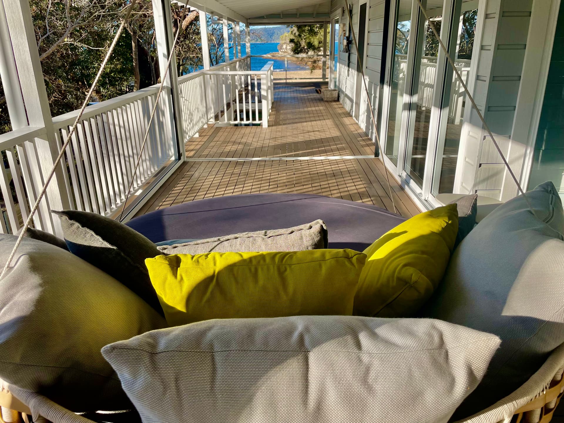 View from the swing daybed along the verandah to Pearl Beach and the blue water beyond